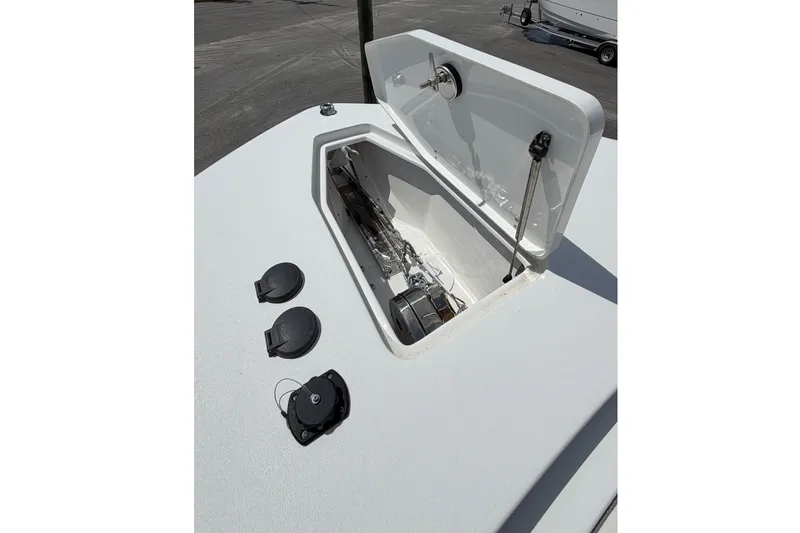 Slide: The Image of 2027 Sea Hunt Gamefish 25 boat with open storage compartment, docked outdoors. - 22