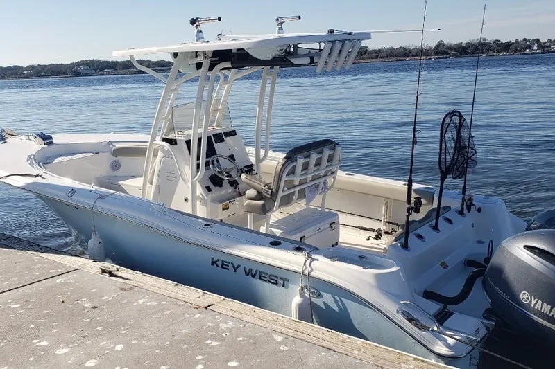 The Image of 2024 Key West 244 Center Console boat docked by the water. - 2