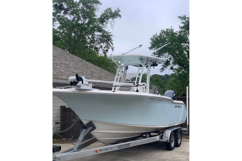 Slide: The Image of 2024 Key West 244 Center Console boat on trailer, parked outdoors. - 1
