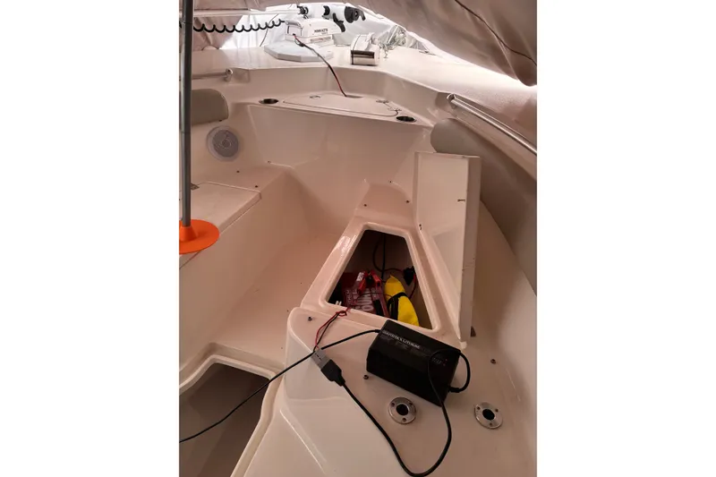 Slide: The Image of 2023 Key West 244 Center Console boat interior with storage compartment and equipment. - 8