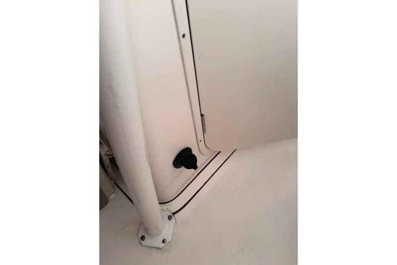 Slide: The Image of Interior detail of 2023 Key West 244 Center Console boat, featuring a white panel and black knob. - 9