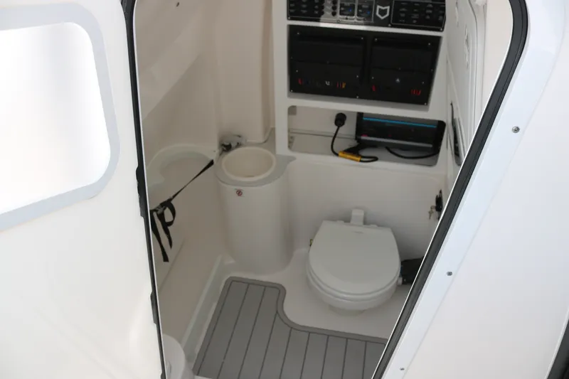 Slide: The Image of Interior of 2027 Sea Fox 288 Commander boat featuring a compact marine toilet. - 14