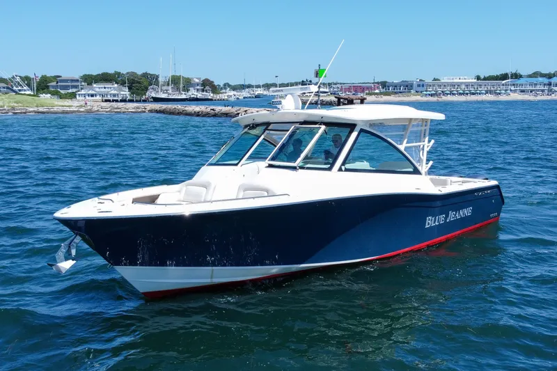 Slide: The Image of 2015 Grady-White Freedom 375 boat on water, near coastal town. - 2