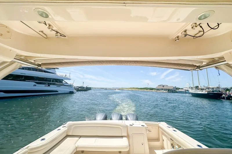 Slide: The Image of 2015 Grady-White Freedom 375 boat cruising in a marina with clear skies. - 35