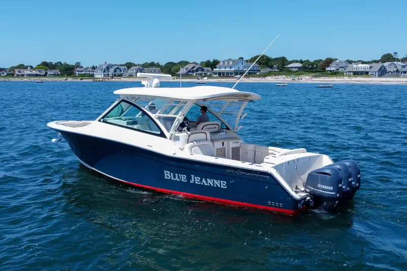 Slide: The Image of 2015 Grady-White Freedom 375 boat named "Blue Jeanne" on the water near coastal homes. - 5