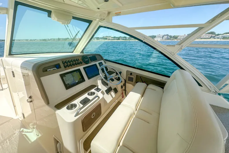 Slide: The Image of 2015 Grady-White Freedom 375 boat interior with helm, steering wheel, and navigation screens. - 20