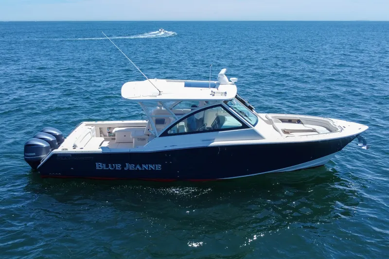 Slide: The Image of 2015 Grady-White Freedom 375 boat on open water, featuring sleek design and twin Yamaha engines. - 11