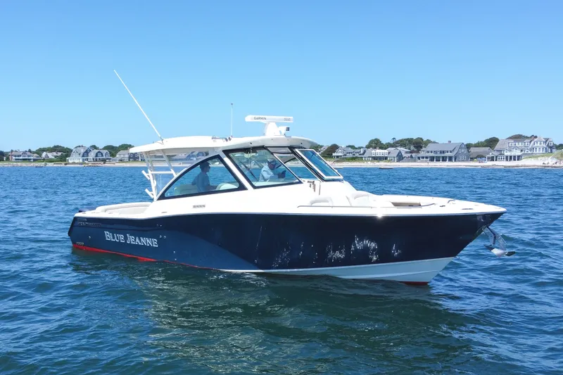 The Image of 2015 Grady-White Freedom 375 boat on water, near coastal homes. - 0