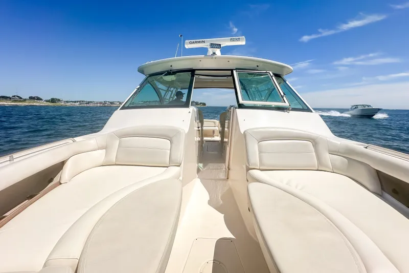 Slide: The Image of 2015 Grady-White Freedom 375 boat on open water, featuring spacious seating and clear skies. - 33