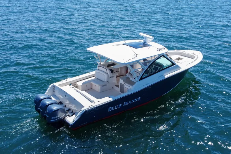 Slide: The Image of 2015 Grady-White Freedom 375 boat on open water, featuring triple Yamaha engines. - 9