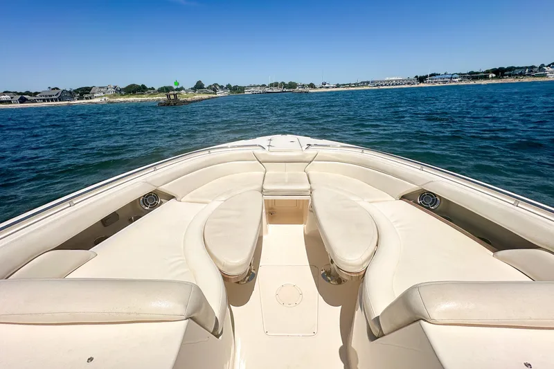 Slide: The Image of 2015 Grady-White Freedom 375 boat with spacious seating, cruising on calm waters. - 29