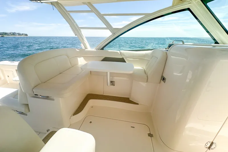 Slide: The Image of 2015 Grady-White Freedom 375 boat interior with white seating and ocean view. - 24