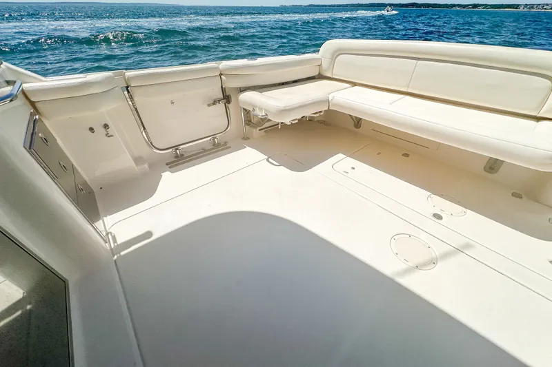 Slide: The Image of 2015 Grady-White Freedom 375 boat deck with seating, overlooking ocean waves. - 38