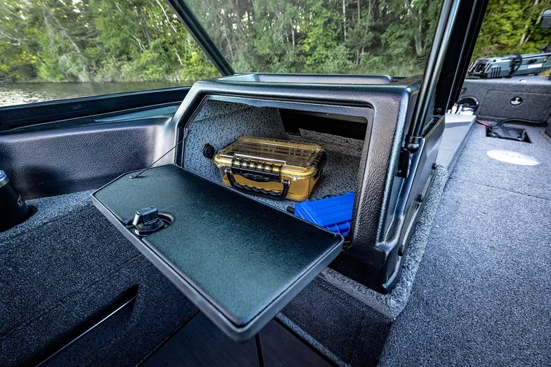 Slide: The Image of Manufacturer Provided Image: Manufacturer Provided Image: 2025 Lund 2025 Impact XS Sport boat storage compartment with gear inside. - 6