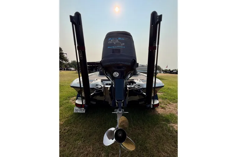 Slide: The Image of 2016 Phoenix 919 ProXP boat rear view with motor and propeller on grass. - 3