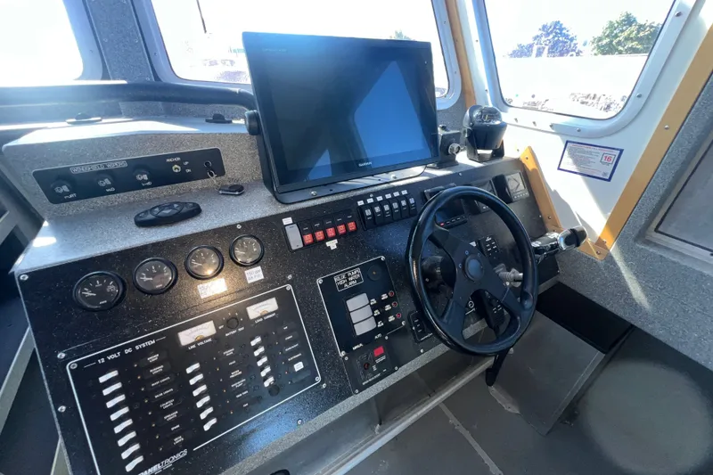 Slide: The Image of Cockpit of 2019 Armstrong Marine 38 Monohull Aluminum boat with steering wheel and control panel. - 15