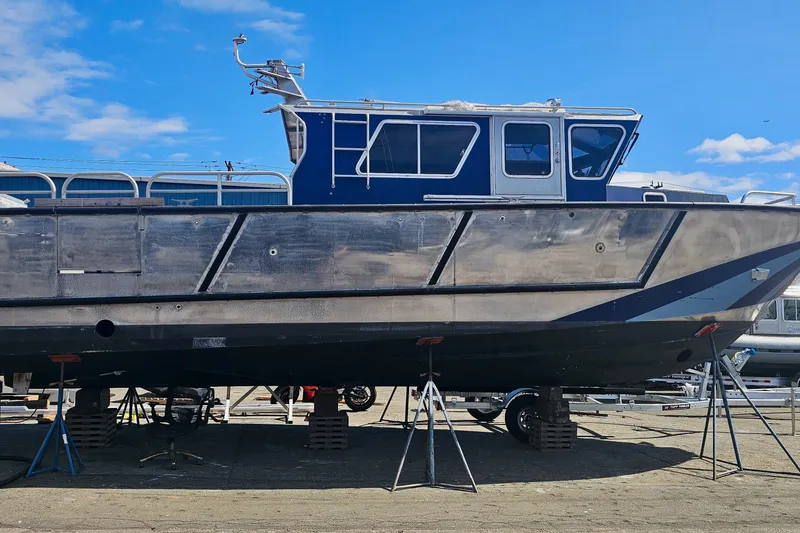 Slide: The Image of 2019 Armstrong Marine 38 Monohull Aluminum boat on stands under a clear blue sky. - 2