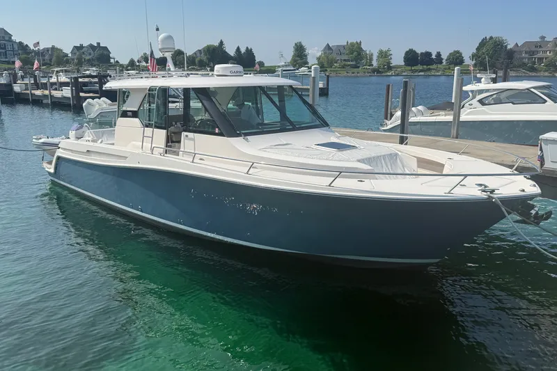 The Image of 2016 Tiara Yachts Q44 docked in a marina, showcasing sleek design and luxury features. - 0