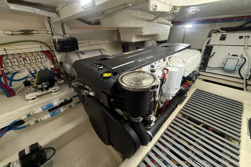 Slide: The Image of Engine room of a 2016 Tiara Yachts Q44, showcasing detailed mechanical components. - 59