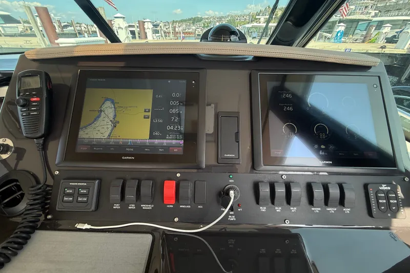 Slide: The Image of 2016 Tiara Yachts Q44 helm with Garmin navigation displays and control panel. - 47
