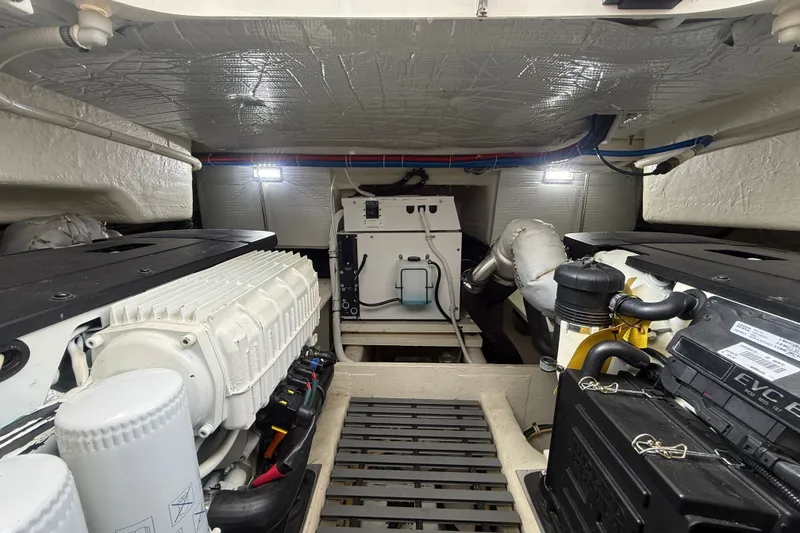 Slide: The Image of Engine room of 2016 Tiara Yachts Q44, showcasing dual engines and mechanical components. - 56