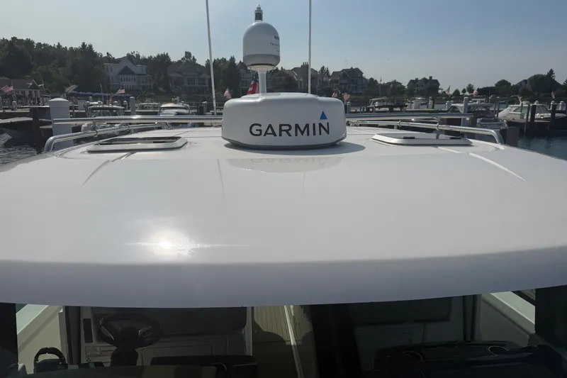 Slide: The Image of 2016 Tiara Yachts Q44 with Garmin radar, docked at a marina. - 52