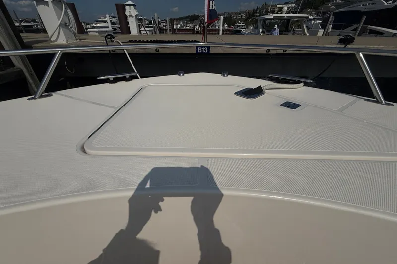 Slide: The Image of 2016 Tiara Yachts Q44 deck view at marina with shadow reflection. - 50