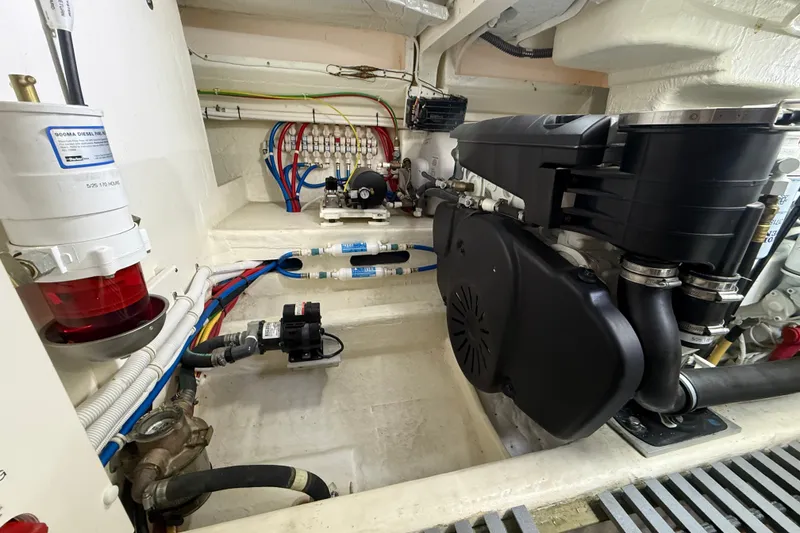 Slide: The Image of Engine room of 2016 Tiara Yachts Q44, showcasing mechanical components and wiring. - 58