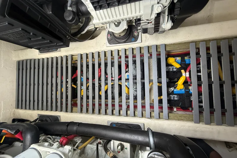 Slide: The Image of Engine compartment of a 2016 Tiara Yachts Q44, showcasing battery setup and wiring. - 61