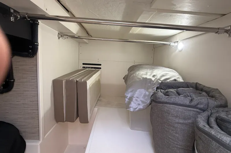 Slide: The Image of Interior storage space of 2016 Tiara Yachts Q44, featuring cushions and bedding. - 38