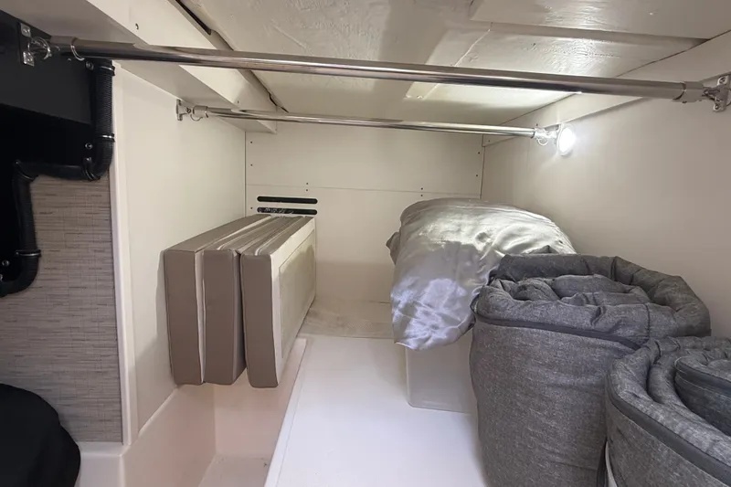 Slide: The Image of 2016 Tiara Yachts Q44 interior storage area with cushions and bedding. - 39