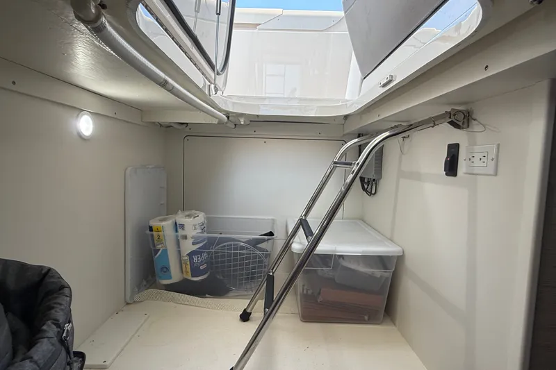 Slide: The Image of 2016 Tiara Yachts Q44 interior storage area with ladder and supplies. - 44