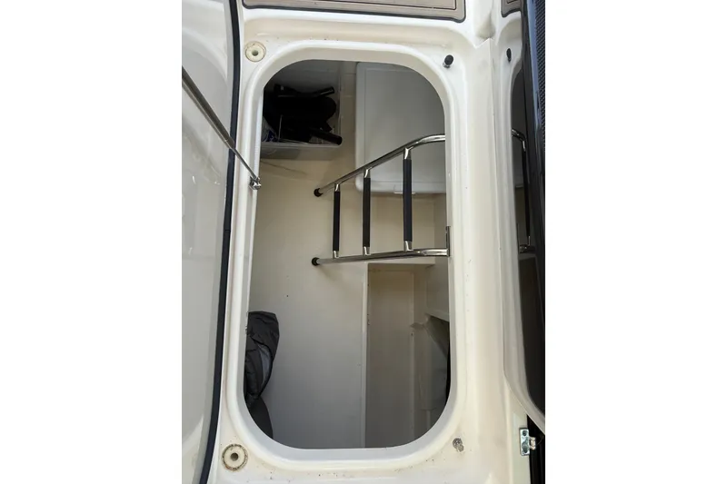 Slide: The Image of 2016 Tiara Yachts Q44 storage compartment with ladder and interior view. - 37