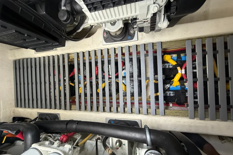 Slide: The Image of Engine compartment of 2016 Tiara Yachts Q44, showcasing battery setup and wiring. - 62