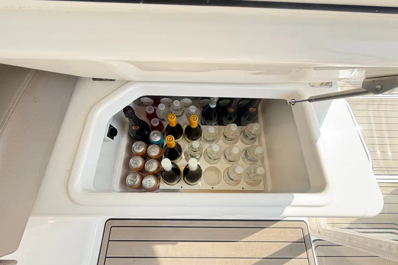 Slide: The Image of Built-in cooler on 2016 Tiara Yachts Q44, stocked with beverages. - 15