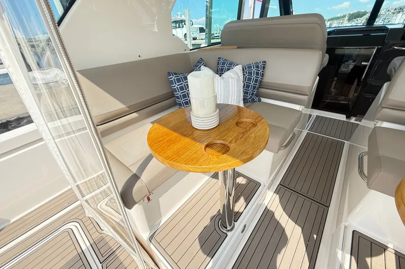 Slide: The Image of Luxurious interior of 2016 Tiara Yachts Q44 with elegant seating and wooden table. - 13