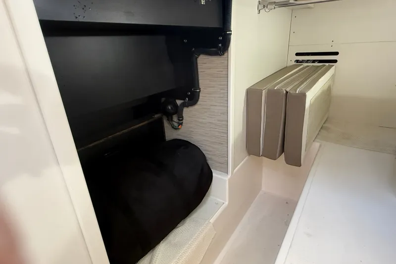 Slide: The Image of Interior storage area of a 2016 Tiara Yachts Q44, featuring cushions and equipment. - 41