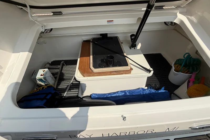 Slide: The Image of Storage compartment of a 2016 Tiara Yachts Q44, featuring various boating accessories. - 36
