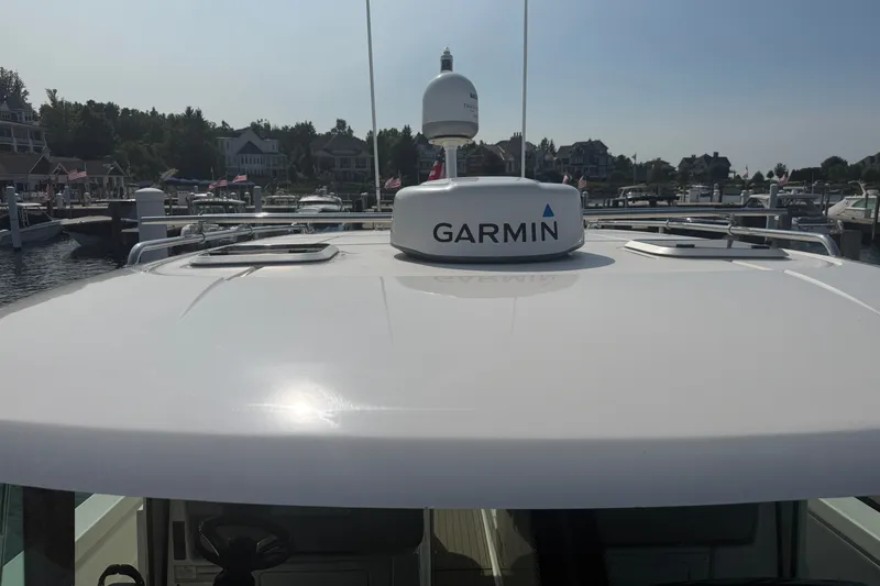 Slide: The Image of 2016 Tiara Yachts Q44 with Garmin equipment, docked at a marina. - 53