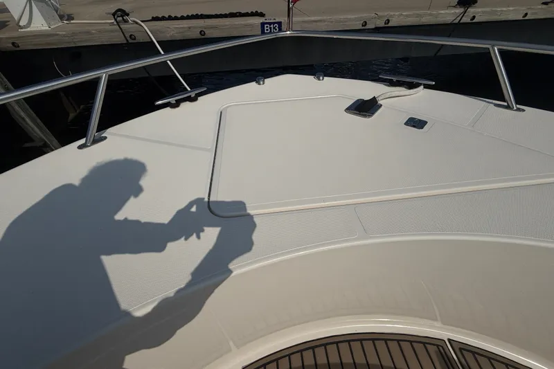 Slide: The Image of Bow of 2016 Tiara Yachts Q44 with shadow of person taking a photo. - 49