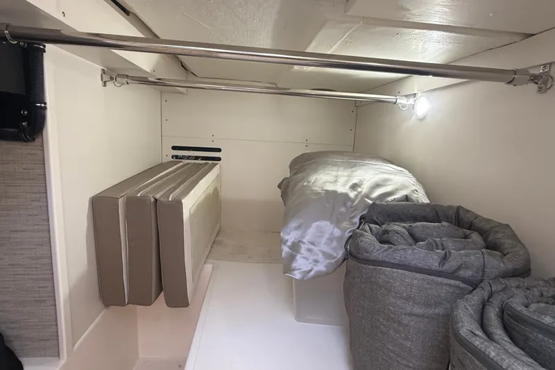 Slide: The Image of 2016 Tiara Yachts Q44 interior storage area with cushions and bedding. - 40