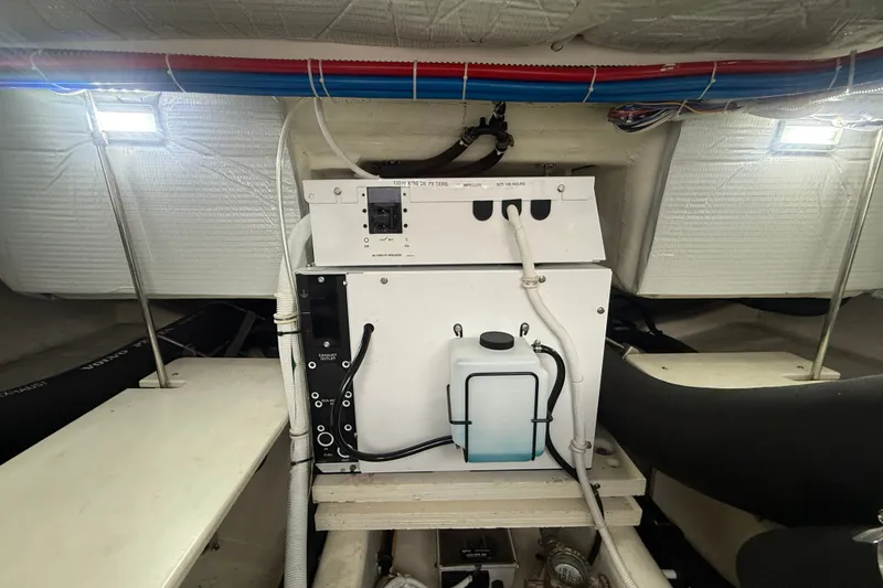 Slide: The Image of Engine room of 2016 Tiara Yachts Q44, featuring electrical components and wiring. - 63