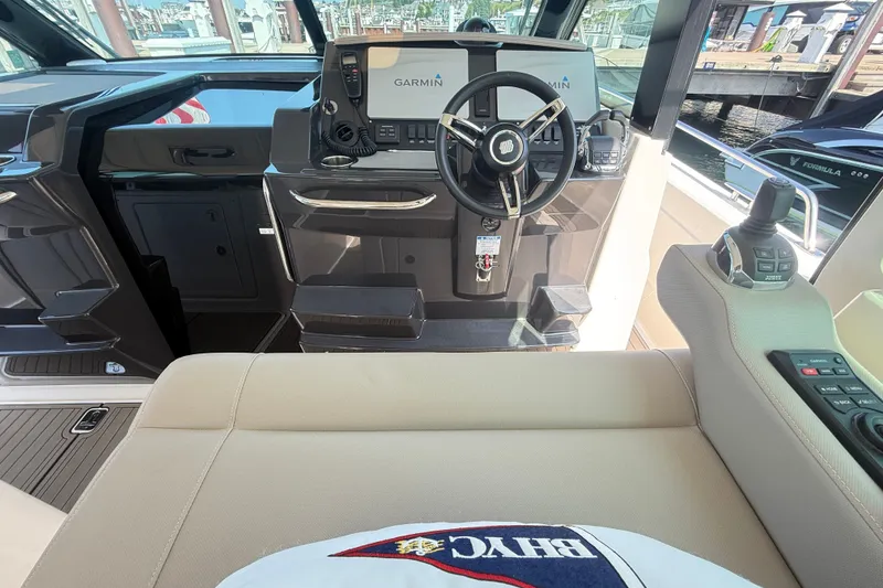 Slide: The Image of Helm of 2016 Tiara Yachts Q44 with Garmin navigation system and joystick controls. - 16