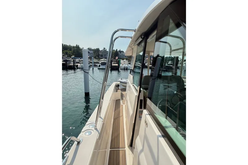 Slide: The Image of 2016 Tiara Yachts Q44 docked, showcasing sleek design and waterfront view. - 22
