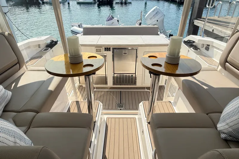 Slide: The Image of Luxurious 2016 Tiara Yachts Q44 interior with elegant seating and tables, docked at marina. - 23