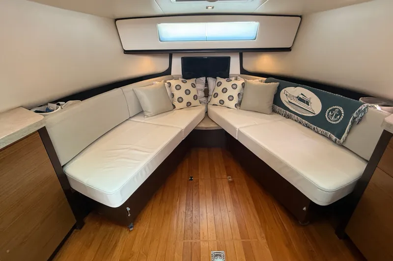 Slide: The Image of Luxurious interior of 2016 Tiara Yachts Q44 with elegant seating and decorative pillows. - 25