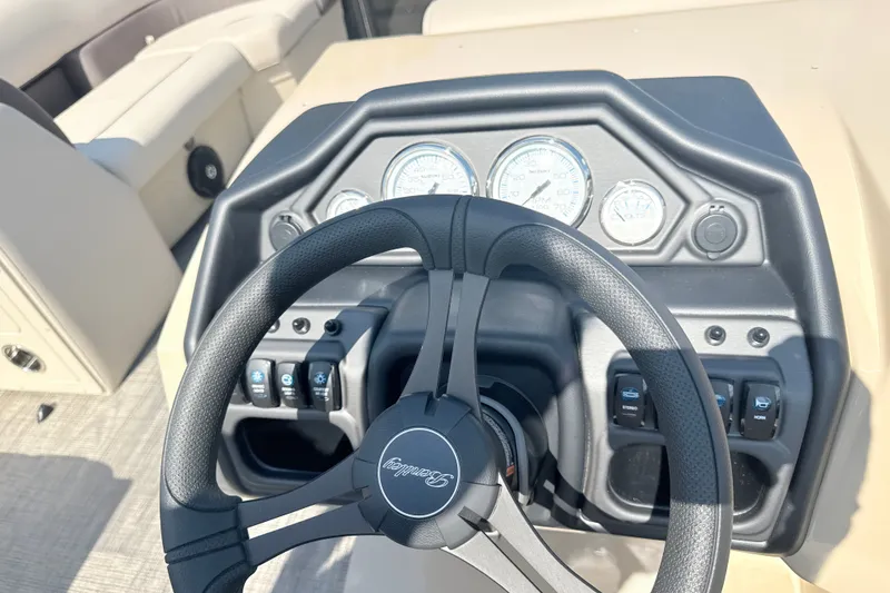 Slide: The Image of Steering console of 2026 Bentley Pontoons Legacy 220 Navigator with gauges and controls. - 21