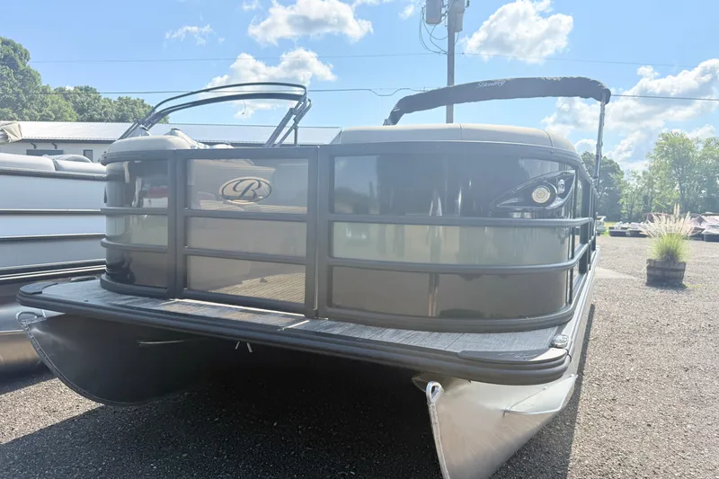 Slide: The Image of 2026 Bentley Pontoons Legacy 220 Navigator on display under a clear blue sky. - 1