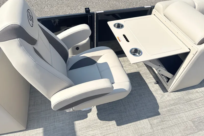 Slide: The Image of 2026 Bentley Pontoons Legacy 220 Navigator interior with luxurious seating and foldable table. - 12