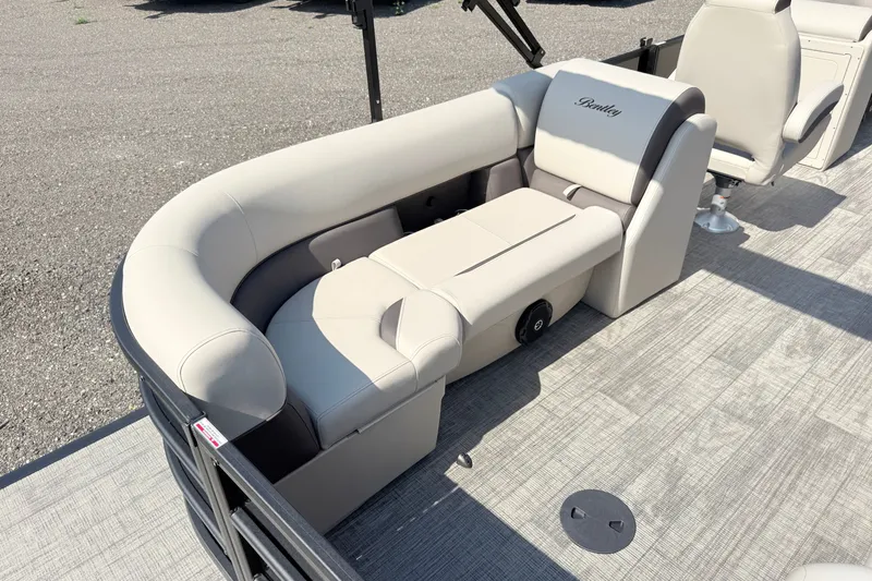 Slide: The Image of 2026 Bentley Pontoons Legacy 220 Navigator with luxurious seating on deck. - 5